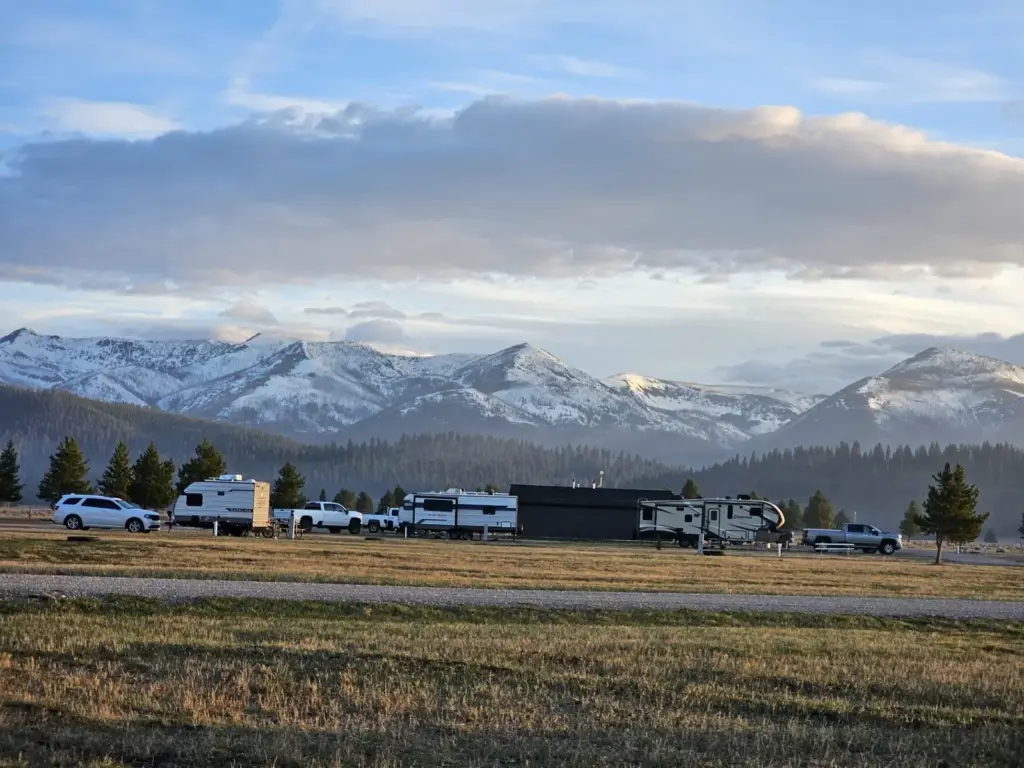 RVs at the campground below snow covered peaks, Lincoln, Montana